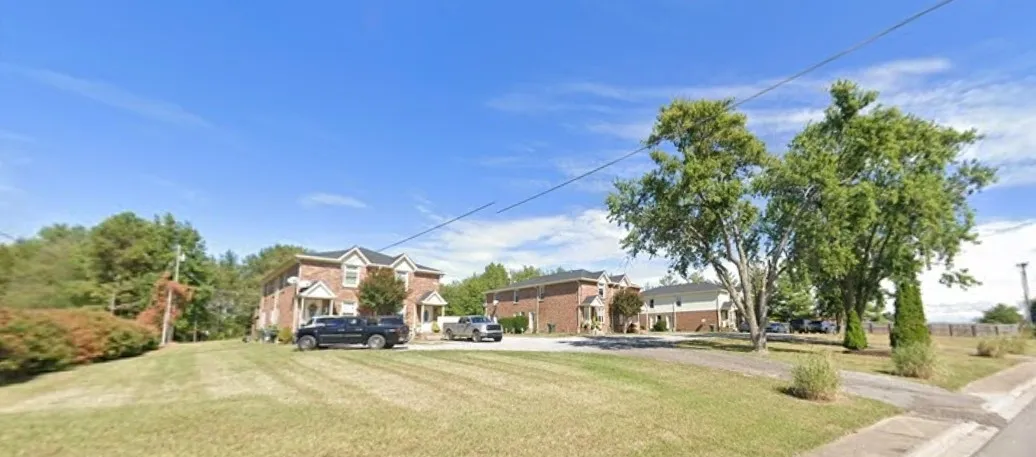 Suburban street with houses and trees.